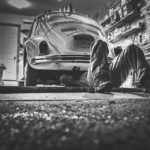 man repairing a beetle